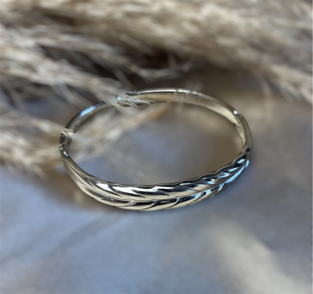 Sølvfarvet armbånd med fjereffekt – fordi dit håndled fortjener at flyve højt med SpohrCopenhagen.