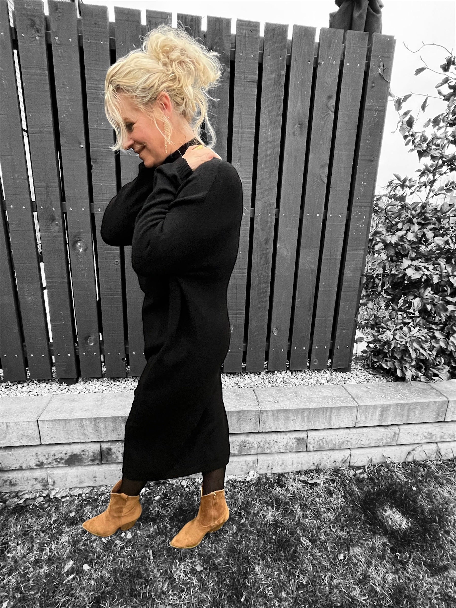 Sideprofil af modellen, der fremhæver kjolens afslappede pasform 